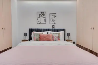 a bedroom with a large white bed with pink pillows at Stefanos flat in the heart of Koukaki 2BD in Athens