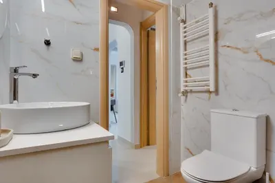 a white bathroom with a toilet and a sink at Stefanos flat in the heart of Koukaki 2BD in Athens