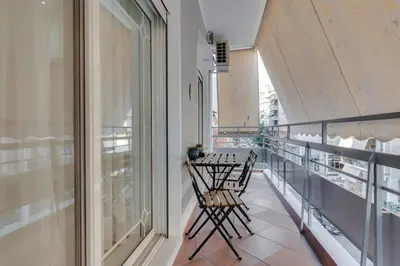 a balcony with two chairs and a table at Stefanos flat in the heart of Koukaki 2BD in Athens