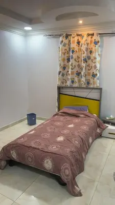 a bedroom with a bed with a brown blanket at أثينا in Athens