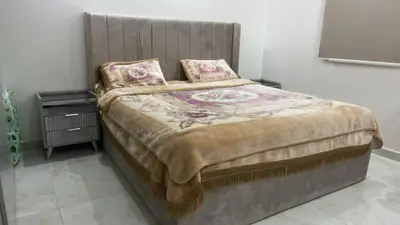 a large bed with a wooden headboard in a bedroom at أثينا in Athens