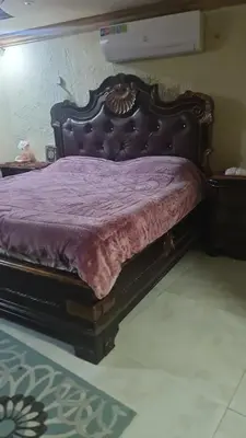 a bed in a bedroom with a purple bedspread at أثينا in Athens