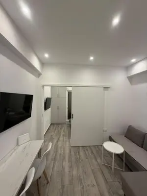 a living room with a couch and a table and chairs at ATH Gray House in Athens