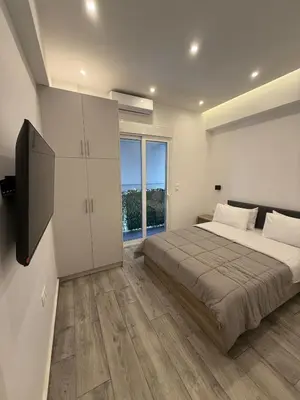 a bedroom with a bed and a large window at ATH Gray House in Athens