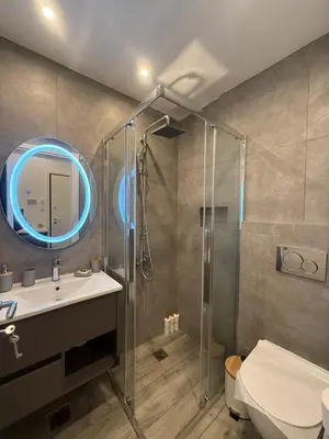 a bathroom with a glass shower and a sink at ATH Gray House in Athens