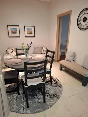 a living room with a table and chairs and a couch at Marina's Sweet Home in Athens