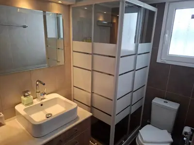 a bathroom with a sink and a shower and a toilet at Marina's Sweet Home in Athens