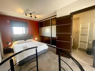 a bedroom with a bed and some chairs in it at Metaxourgio Apartments in Athens