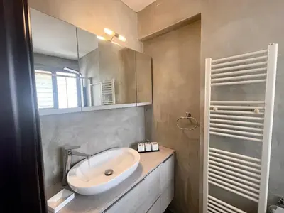 a bathroom with a sink and a mirror at Metaxourgio Apartments in Athens