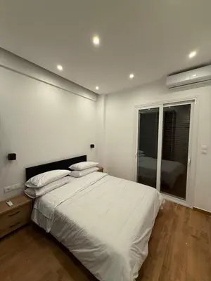 a white bedroom with a bed and a window at ATH Lux apartment in Athens