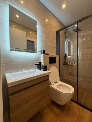 a bathroom with a toilet and a sink and a mirror at ATH Lux apartment in Athens