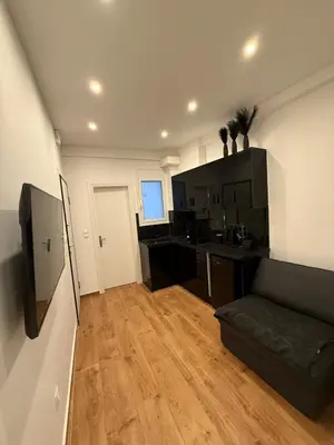 a living room with a couch and a kitchen at ATH Lux apartment in Athens