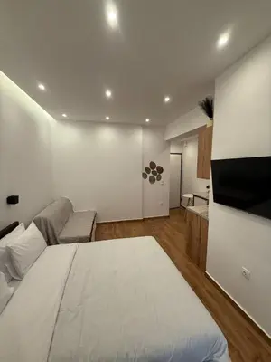 a bedroom with a large white bed and a couch at ATH Cozy Studio in Athens