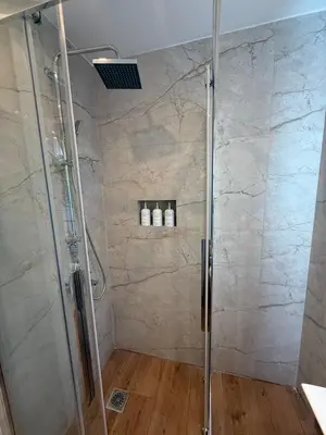 a bathroom with a shower with two bottles on the wall at ATH Cozy Studio in Athens