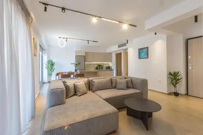a living room with a couch and a table at Raise Pagrati Serviced Apartments in Athens