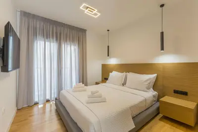 a bedroom with a large bed with two towels on it at Raise Pagrati Serviced Apartments in Athens