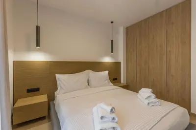 a bedroom with a bed with towels on it at Raise Pagrati Serviced Apartments in Athens