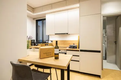 a bottle of wine on a table in a kitchen at Rooms151 Smart Suite in the Center of Athens 1st floor-2S in Athens