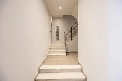 a staircase in a building with white walls at Rooms151 Smart Suite in the Center of Athens 1st floor-2S in Athens