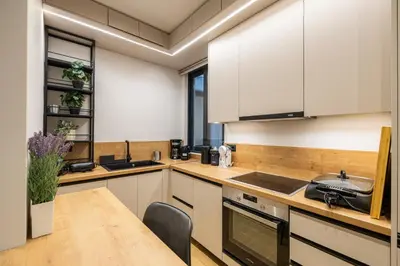 a kitchen with white cabinets and a wooden counter top at Rooms151 Smart Suite in the Center of Athens 1st floor-2S in Athens
