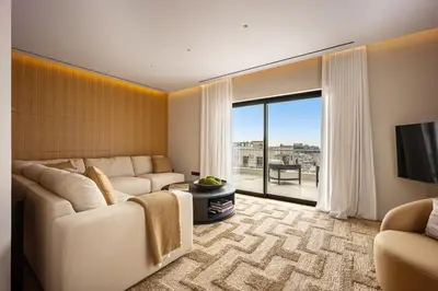 a living room with a couch and a large window at The Athenian Luxury Penthouse by GK Properties in Athens