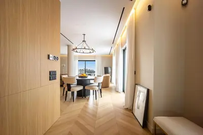 a dining room and living room with a table and chairs at The Athenian Luxury Penthouse by GK Properties in Athens