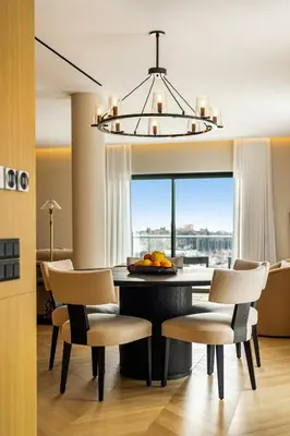 a dining room with a table and chairs and a chandelier at The Athenian Luxury Penthouse by GK Properties in Athens