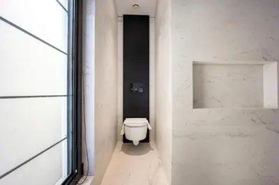 a bathroom with a white toilet in a hallway at The Athenian Luxury Penthouse by GK Properties in Athens