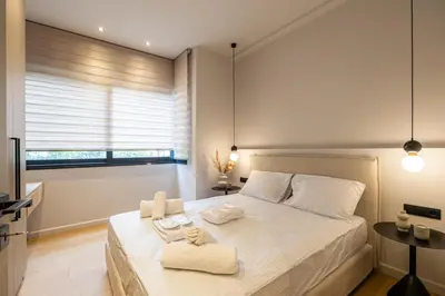 a bedroom with a large bed with towels on it at Rooms151 Smart Suite in the Heart of Athens 1st floor-2B in Athens