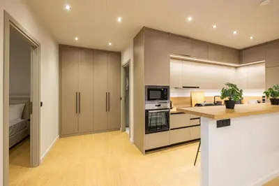 a kitchen with white cabinets and a counter top at Rooms151 Smart Suite in the Heart of Athens 1st floor-2B in Athens