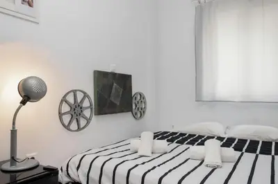 a bedroom with a black and white bed and a lamp at Circle Mirror Center Inn in Athens