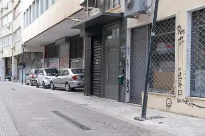 a street with cars parked in front of a building at Circle Mirror Center Inn in Athens