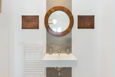 a bathroom with a white sink and a mirror at Circle Mirror Center Inn in Athens
