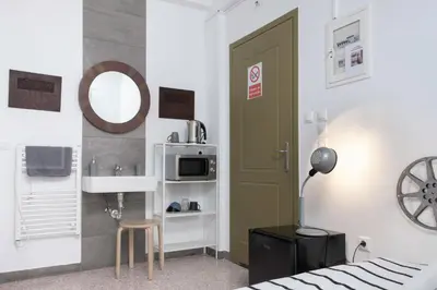 a bedroom with a bed and a sink and a mirror at Circle Mirror Center Inn in Athens