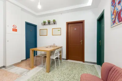 a dining room with a wooden table and two doors at Circle Mirror Center Inn in Athens
