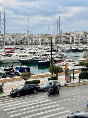 a group of cars parked at a marina with boats at Cozy Apartment View Pasalimani in Piraeus