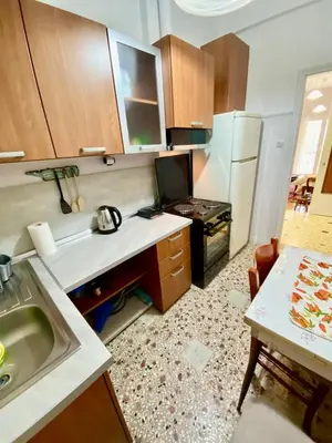 a small kitchen with a sink and a refrigerator at Cozy Apartment View Pasalimani in Piraeus