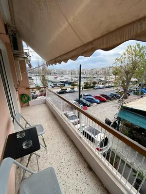 a balcony with a view of a parking lot at Cozy Apartment View Pasalimani in Piraeus