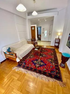 a living room with a couch and a rug at Cozy Apartment View Pasalimani in Piraeus