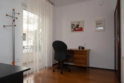 an office with a chair and a desk and a window at Apartment near Acropolis in Athens