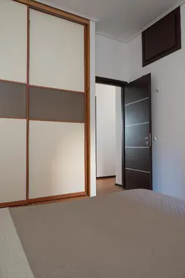 a bedroom with sliding glass doors and a bed at Apartment near Acropolis in Athens