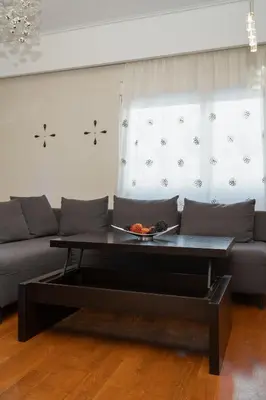 a living room with a couch and a coffee table at Apartment near Acropolis in Athens
