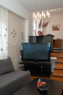 a living room with a flat screen tv at Apartment near Acropolis in Athens