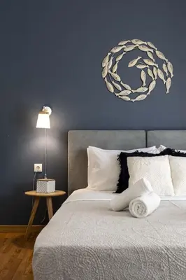 a bedroom with a bed with a blue wall at Kosmos Serenity - 1BR, Neos Kosmos in Athens