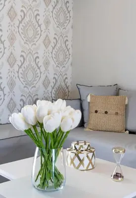 a vase of white flowers on a table next to a couch at Kosmos Serenity - 1BR, Neos Kosmos in Athens