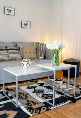 a living room with a couch and two white tables at Kosmos Serenity - 1BR, Neos Kosmos in Athens
