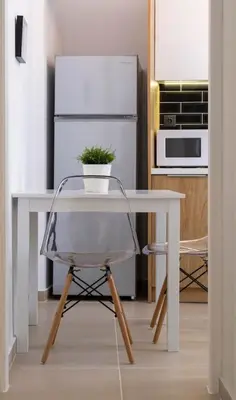 a white table with a plant on it in a kitchen at Kosmos Serenity - 1BR, Neos Kosmos in Athens