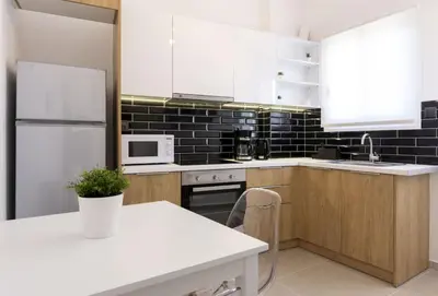 a kitchen with white appliances and a white counter top at Kosmos Serenity - 1BR, Neos Kosmos in Athens