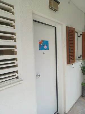 a door with a sticker on it next to a wall at relax studio appartment in Porto Rafti