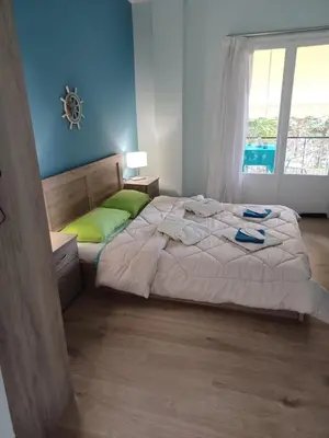 a bedroom with a large bed and a window at relax studio appartment in Porto Rafti